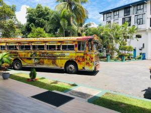 a yellow bus parked in front of a building at G.M.T.SORABORA VILLAGE HOTEL in Mahiyangana