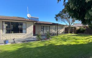 a house with a green lawn in front of it at 4bed 2bath house 5 mins walk to Palms & Golf club in Christchurch