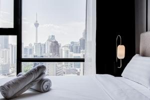 a bedroom with a white bed and a large window at Axon Residence at Pavilion KLCC KL Tower view by KIMIRO in Kuala Lumpur