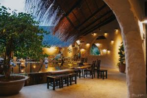 a restaurant with tables and chairs and a fountain at Emo Coffee Home - Venuestay in Dak Lak