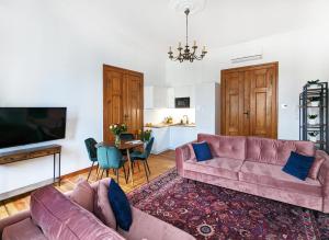 a living room with two couches and a tv at Apartamenty Strzelecka 34 in Poznań