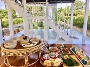 a buffet of food on a table in a house at Huen Chaivaree in Nan
