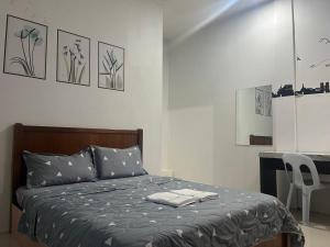 a bedroom with a bed and a desk in it at Joyful homestay Miri in Miri