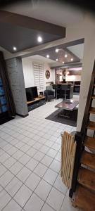 a large living room with a couch and a kitchen at La maison d hôte d emmanuelle in Saint-Antoine-la-Forêt