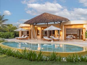 a villa with a swimming pool and a resort at Ana Mandara Cam Ranh in Cam Ranh