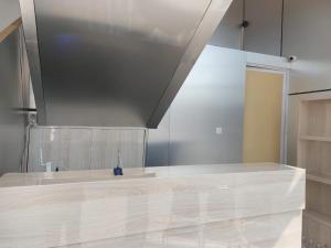 a kitchen with a counter top and a ceiling at V Quin in Semarang +3 photos