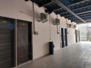 a hallway with a door and a tile floor at V Quin in Semarang