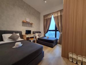 a bedroom with a bed and a desk and a window at Sunway Paradise Home Staycation PH2120 SELF CHECK IN OUT in Subang Jaya