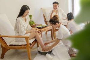 a woman sitting on a chair playing with her foot at Ana Mandara Cam Ranh in Cam Ranh