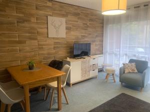 sala de estar con mesa de comedor y TV en Studio de 32 m2 pour 3 personnes pied des pistes, en Les Deux Alpes