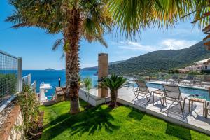 a villa with a view of the ocean at BEACHFRONT WHITE VILLA WİTH PRIVATE SWIMMING POOL in Kalkan