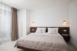 a bedroom with a large bed with two pillows at Villa Artis by IstriaLux in Loborika +33 photos