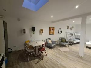 a living room with a table and chairs at Cosy Apartment in Kassel