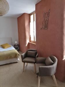 a bedroom with a bed and a chair and a couch at Auberge Buissonniere in Gresse-en-Vercors