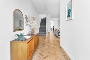 a living room with a dresser and a mirror at Bev's Retreat by Ready Set Stay in Melbourne +12 photos
