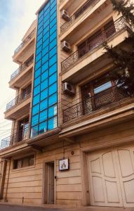 a tall building with a blue glass at ART inn hotel in Baku