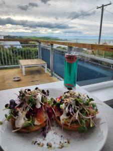 a plate of food and a drink on a table at Beachbach16 - Kakanui in Kakanui