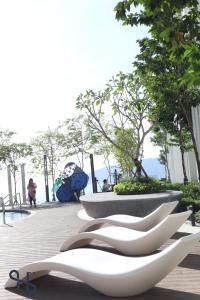 a group of white sculptures sitting on a sidewalk at The Shore by Homesuite' in Kota Kinabalu
