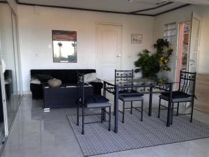 a living room with a dining room table and chairs at roxane Appartement F1 Bis Face A La Mer in Collioure