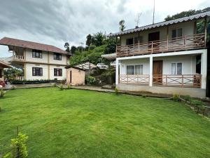 a large yard in front of a house at The Tranquil Farm Stay in Thode