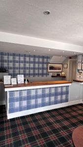 a kitchen with a counter with blue tiles at The Bruce Hotel in Newton Stewart