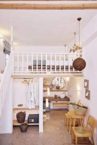 a room with a staircase and a table and chairs at Chrysalis Boutique - Adults Only in Astypalaia