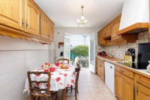 a kitchen with a table with a tablecloth on it at Villa la Farigoulo in Juan-les-Pins