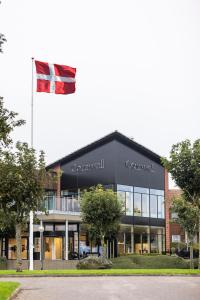 a flag flying in front of a building at Comwell Middelfart in Middelfart