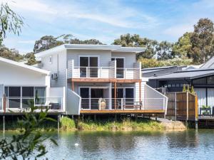 a house on the water with a dock at Reflection in Margaret River Town