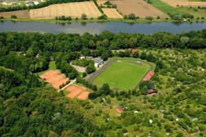 an aerial view of a house with a field and a lake at Hotel Parkowy in Malbork