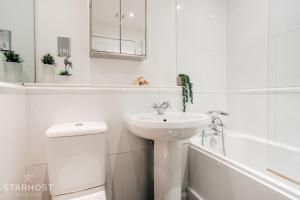 a white bathroom with a sink and a toilet at Central 3 bed apartment at Regents Court, Newbury in Newbury