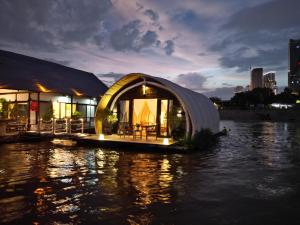 a dome house on the water at night at Floating Jungloo in Phnom Penh