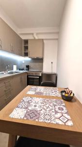 a kitchen with a wooden table with a pattern on it at Vv Cosy Host 2 in Larisa