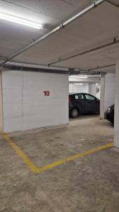 a parking garage with a car parked in it at Vv Cosy Host 2 in Larisa