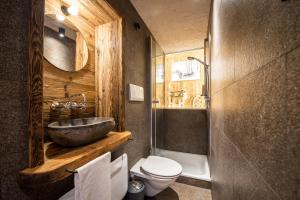 a bathroom with a sink and a toilet at Alm Chalet Oberkofl in San Giacomo