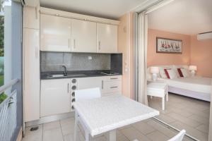 a kitchen with a table and a bed in a room at Appartement T1 sur la plage et vue mer in Le Gosier