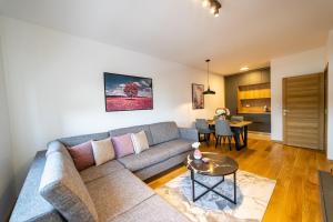 a living room with a couch and a table at Apart Kraft in Podgorica