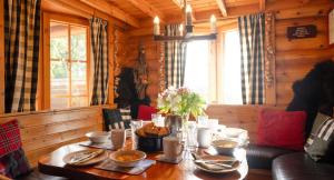 a wooden dining room table with food on it at Beaver Creek Lodge in Aviemore