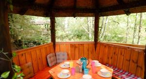 a wooden room with a table and chairs in a cabin at Beaver Creek Lodge in Aviemore