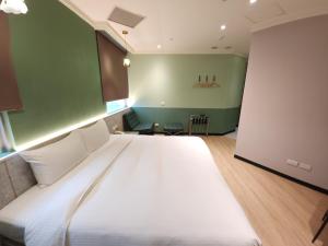 Rúm í herbergi á Merryday Hotel Banqiao