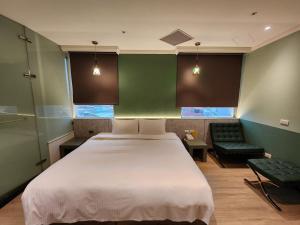 Rúm í herbergi á Merryday Hotel Banqiao