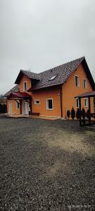 a large orange house with a gravel yard at Penzion Forest 2 in Rozvadov