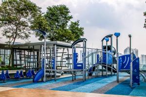 a playground with blue chairs in front of a building at Near SunwayPyramid 2Bed2Bathroom in Subang Jaya