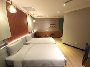 Rúm í herbergi á Merryday Hotel Banqiao