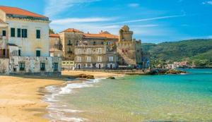 a group of buildings on a beach next to the water at DOLCE DORMIRE in Albanella