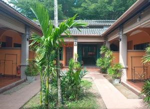 a courtyard of a house with palm trees at Phuket Siam Villas - SHA PLUS in Chalong +28 photos