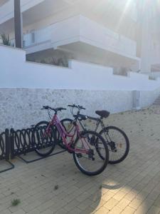 two bikes are parked next to a wall at Ristella Home in Monopoli