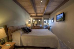 a bedroom with a bed and a tv on the wall at Our Happy Place home in South Lake Tahoe