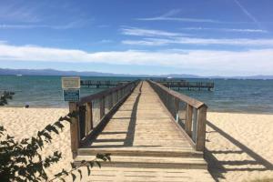 drewniana promenada rozciąga się do oceanu na plaży w obiekcie Our Happy Place home w mieście South Lake Tahoe