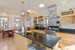 a kitchen with a black counter top and wooden cabinets at West Pacific Ave 320 ~ Pacifico in Telluride